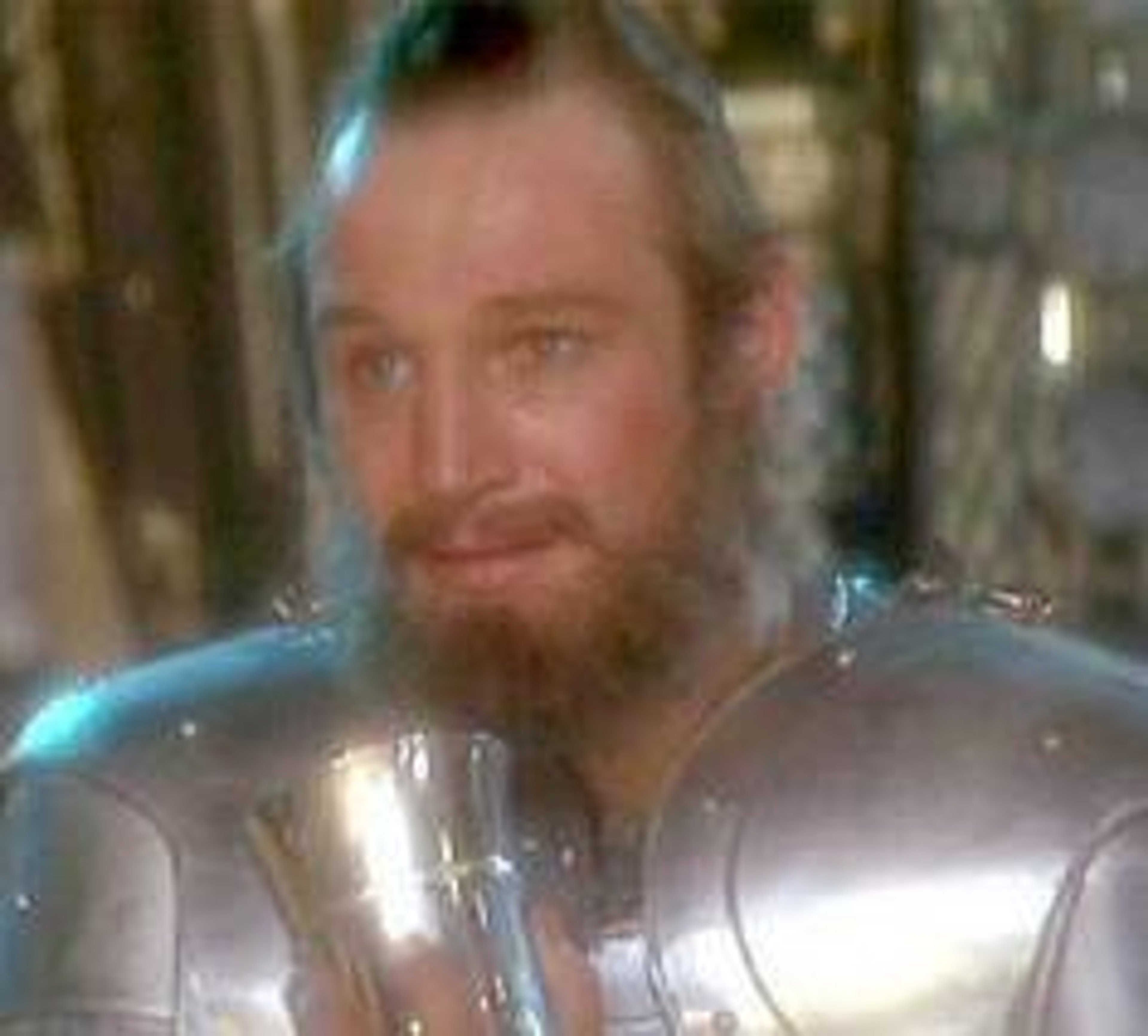 A man in medieval armor holding a sword