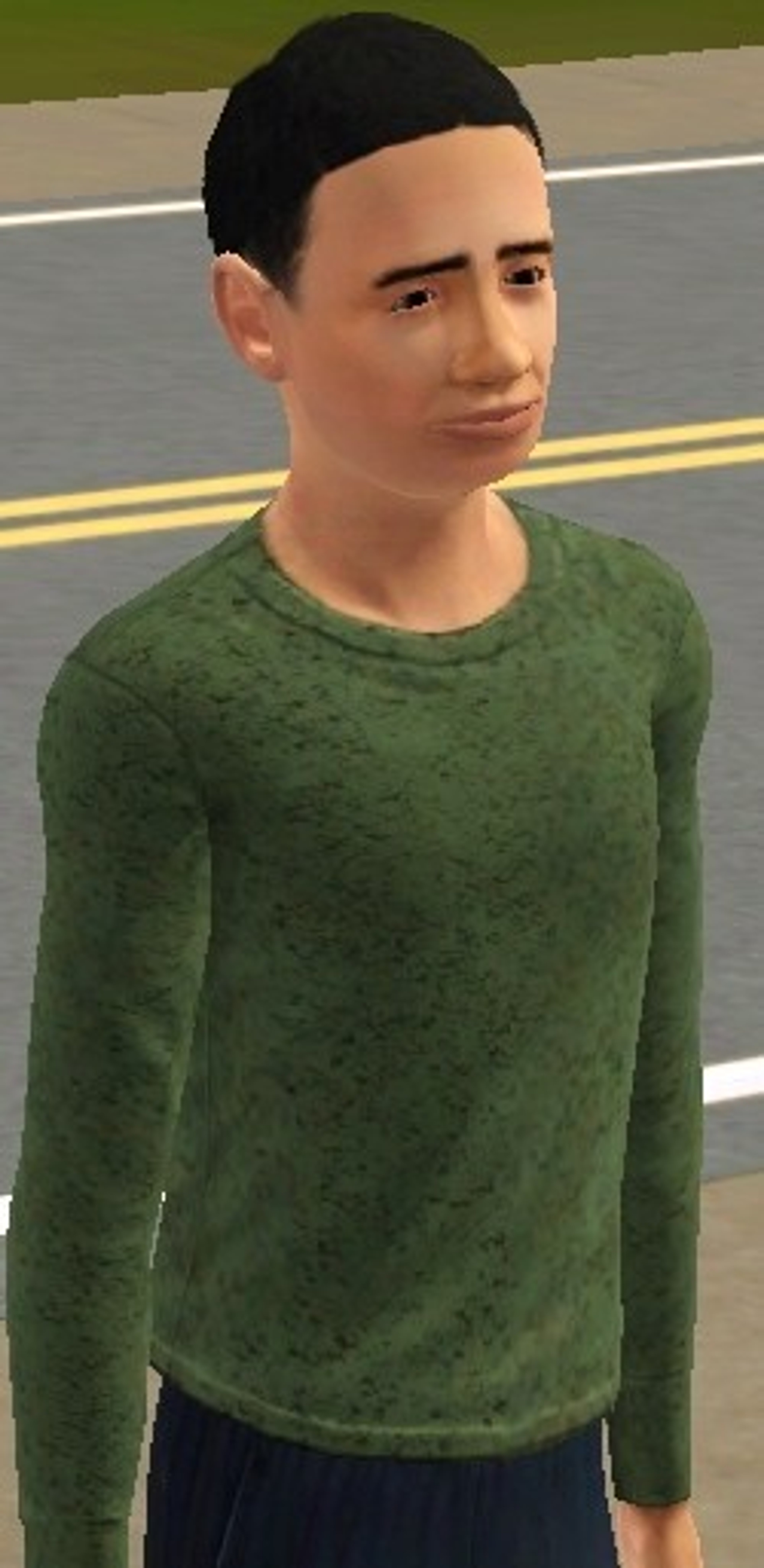 A young man with short dark hair wearing a green sweater
