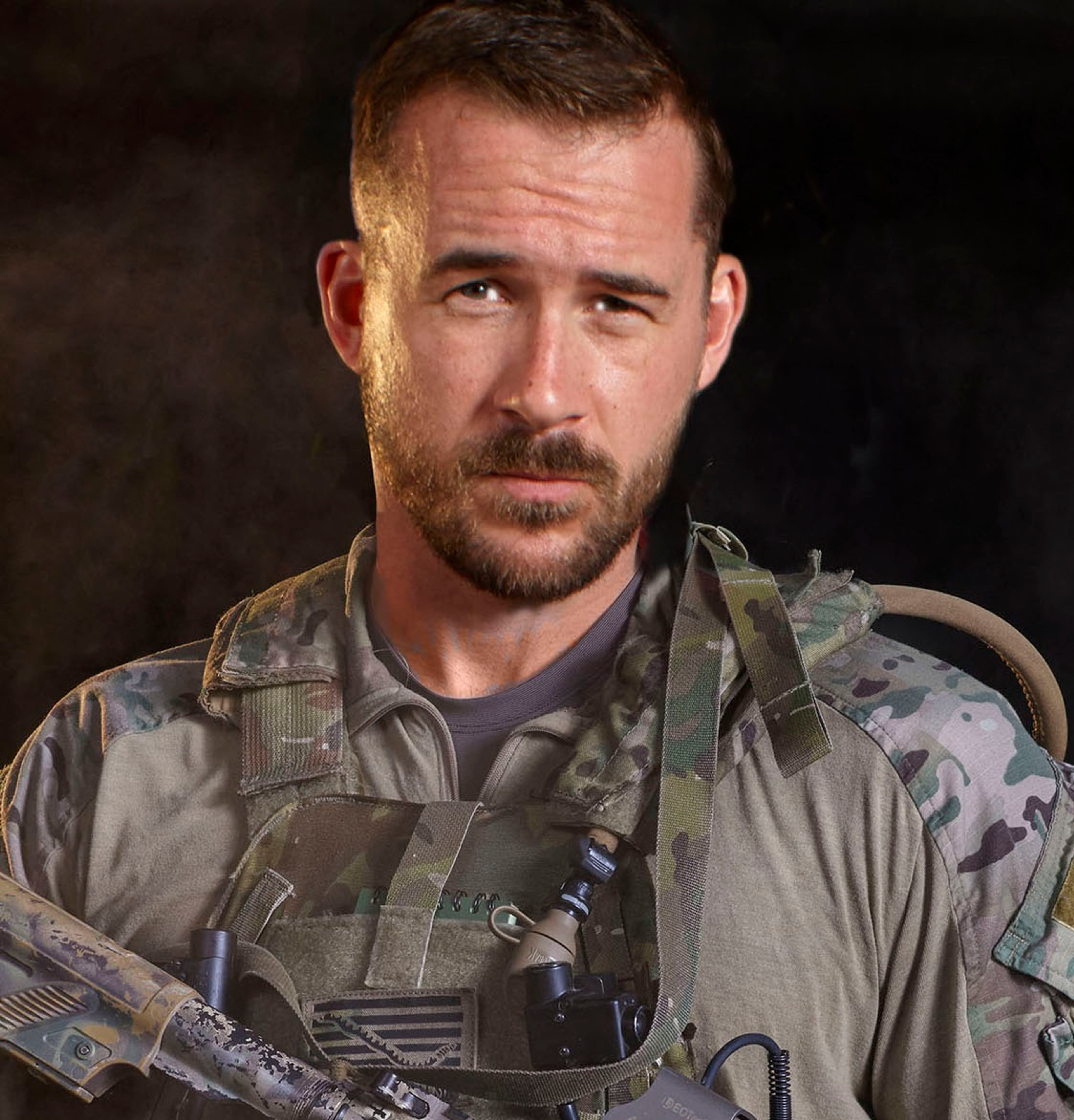 A senior chief petty officer in the United States Navy SEALs with a beard and military uniform