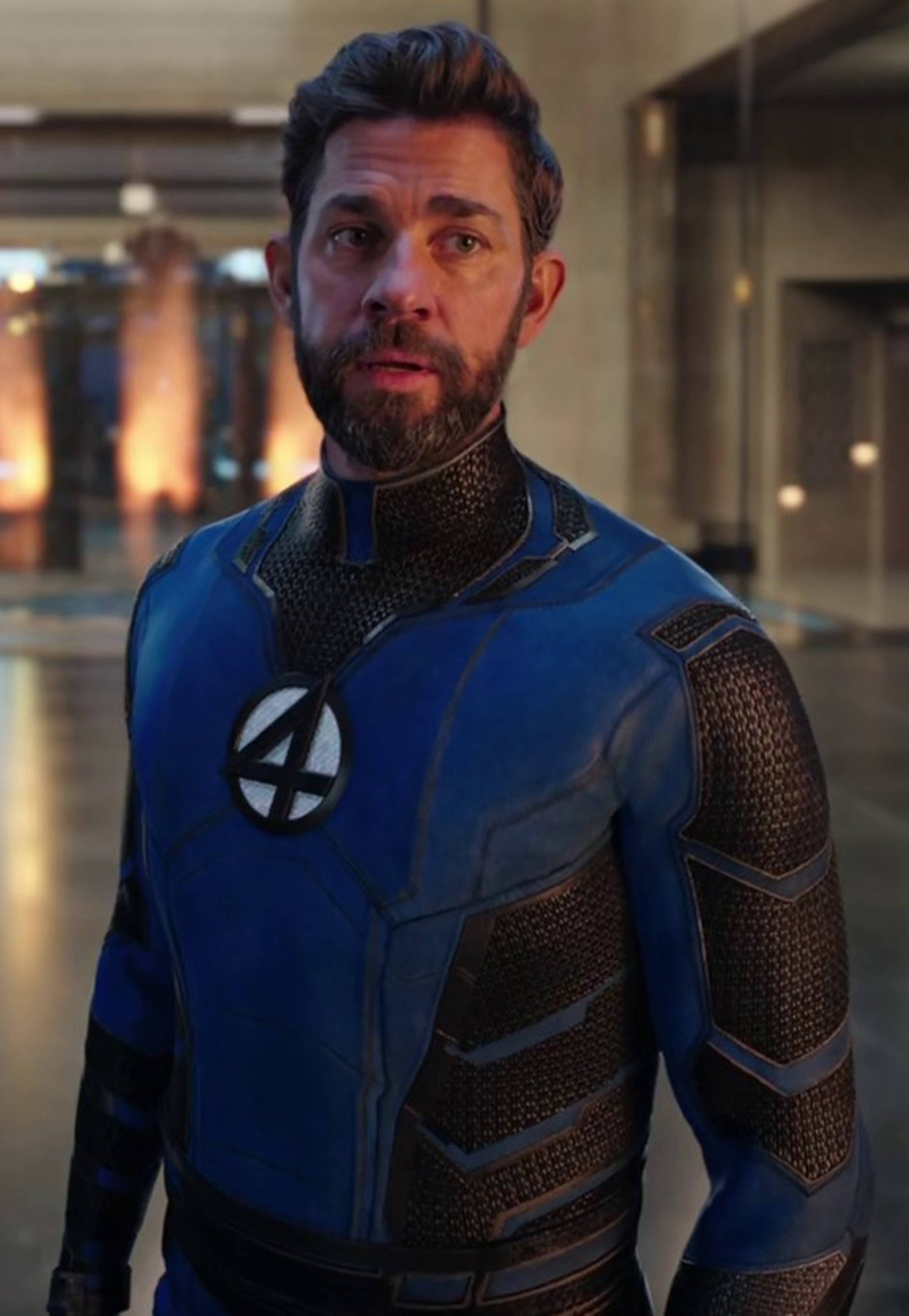 A man in a blue and black superhero costume with the number '4' on his chest