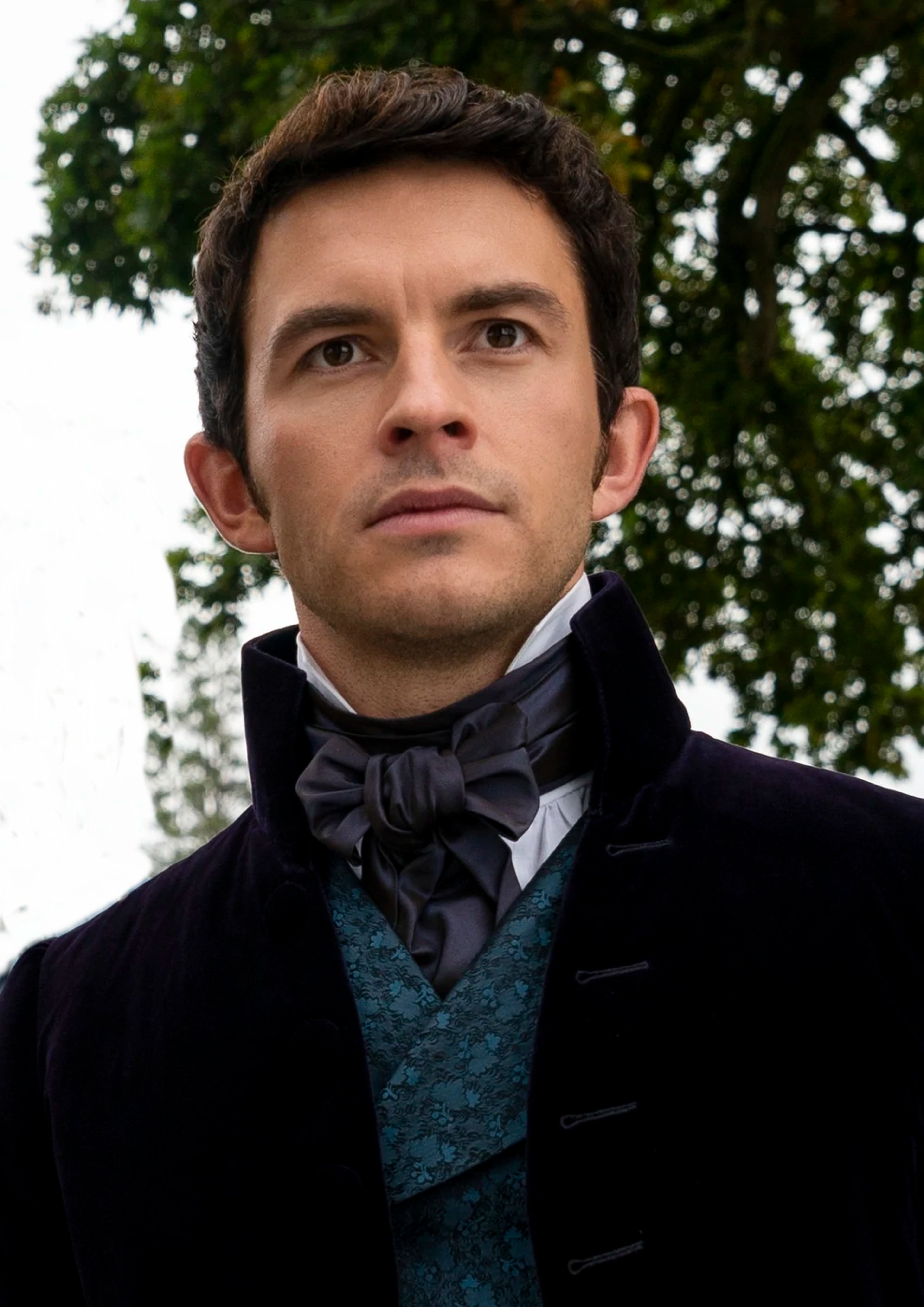 A man in Regency-era attire with a serious expression