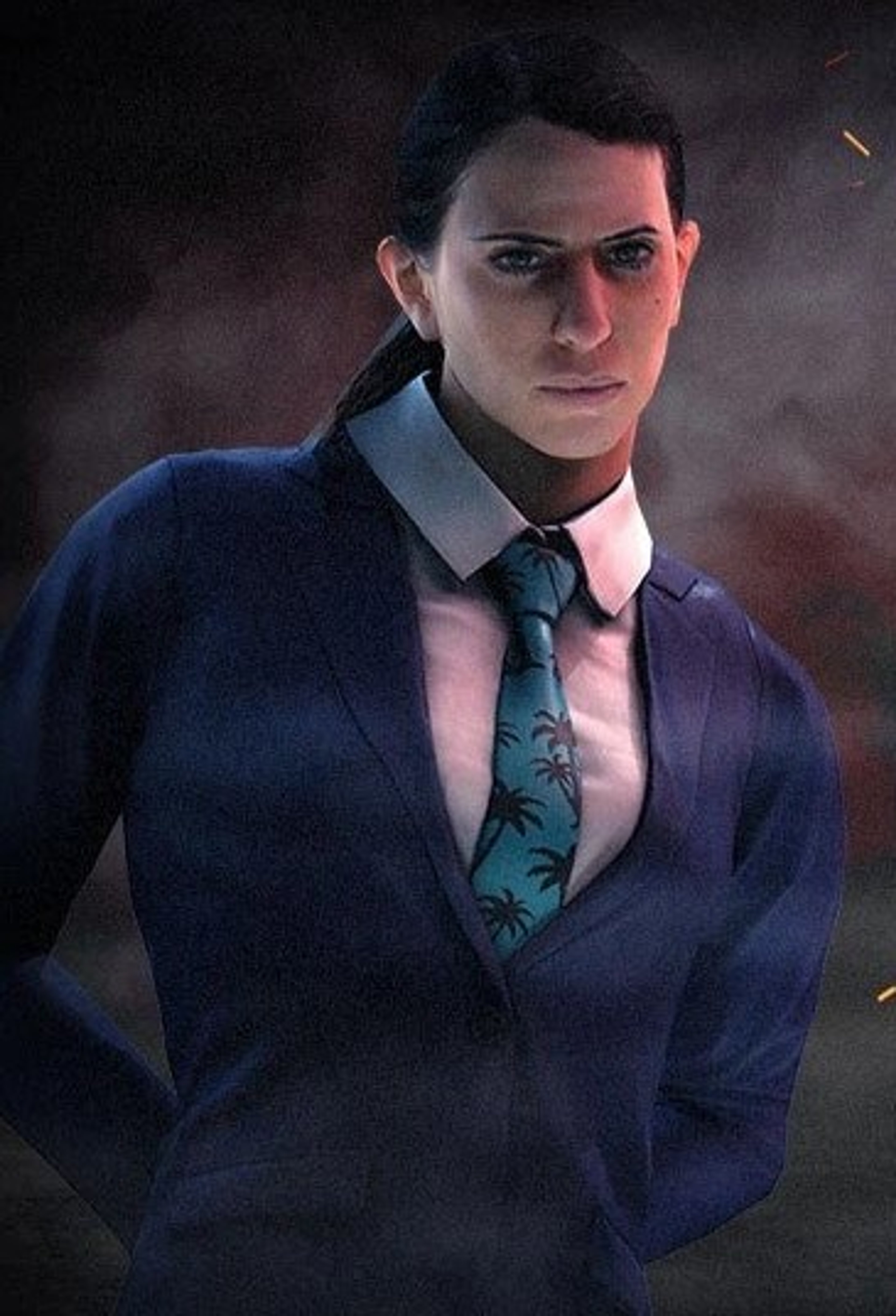 A man in a navy blue suit and patterned tie with a serious expression