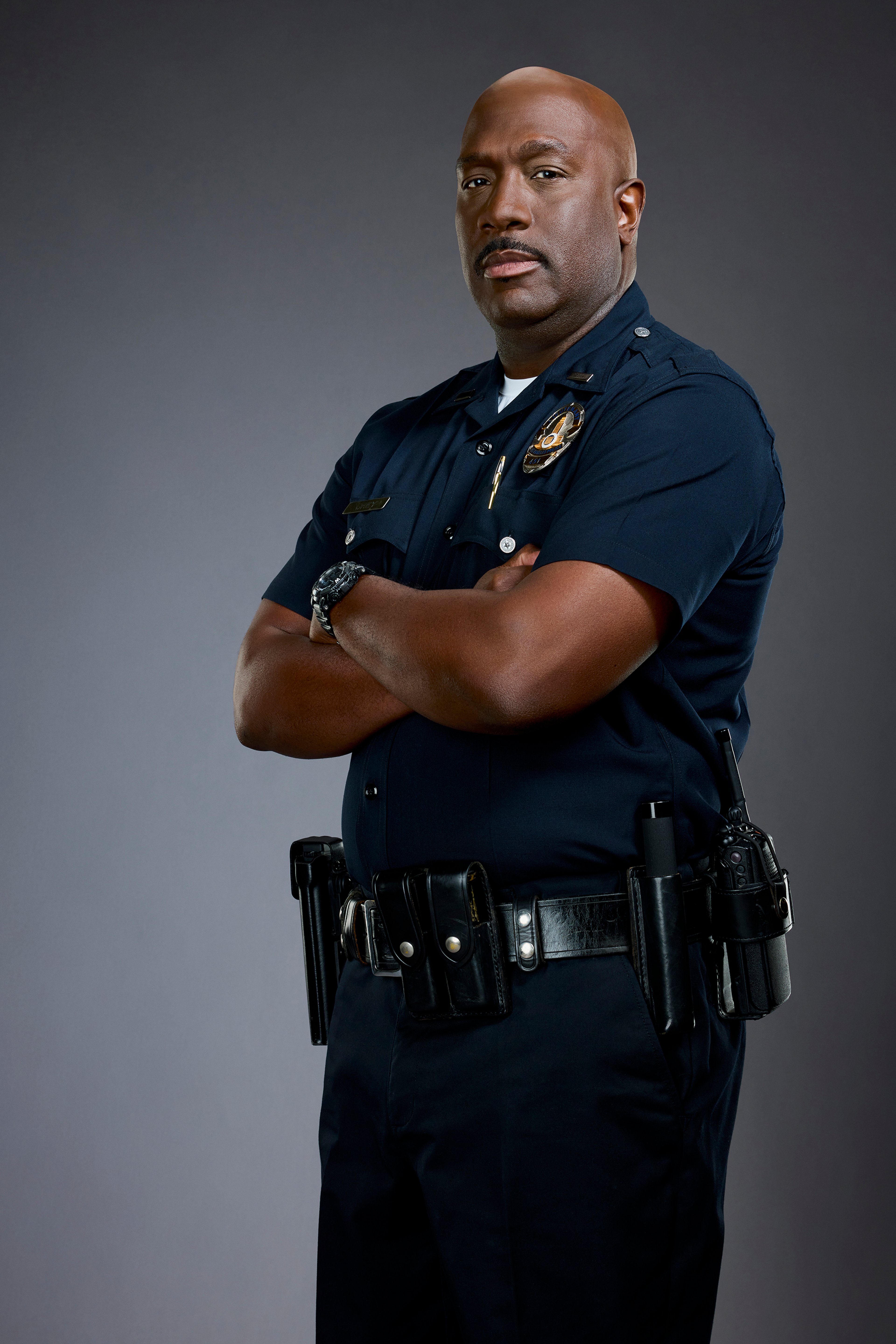 A police officer in uniform with a serious expression