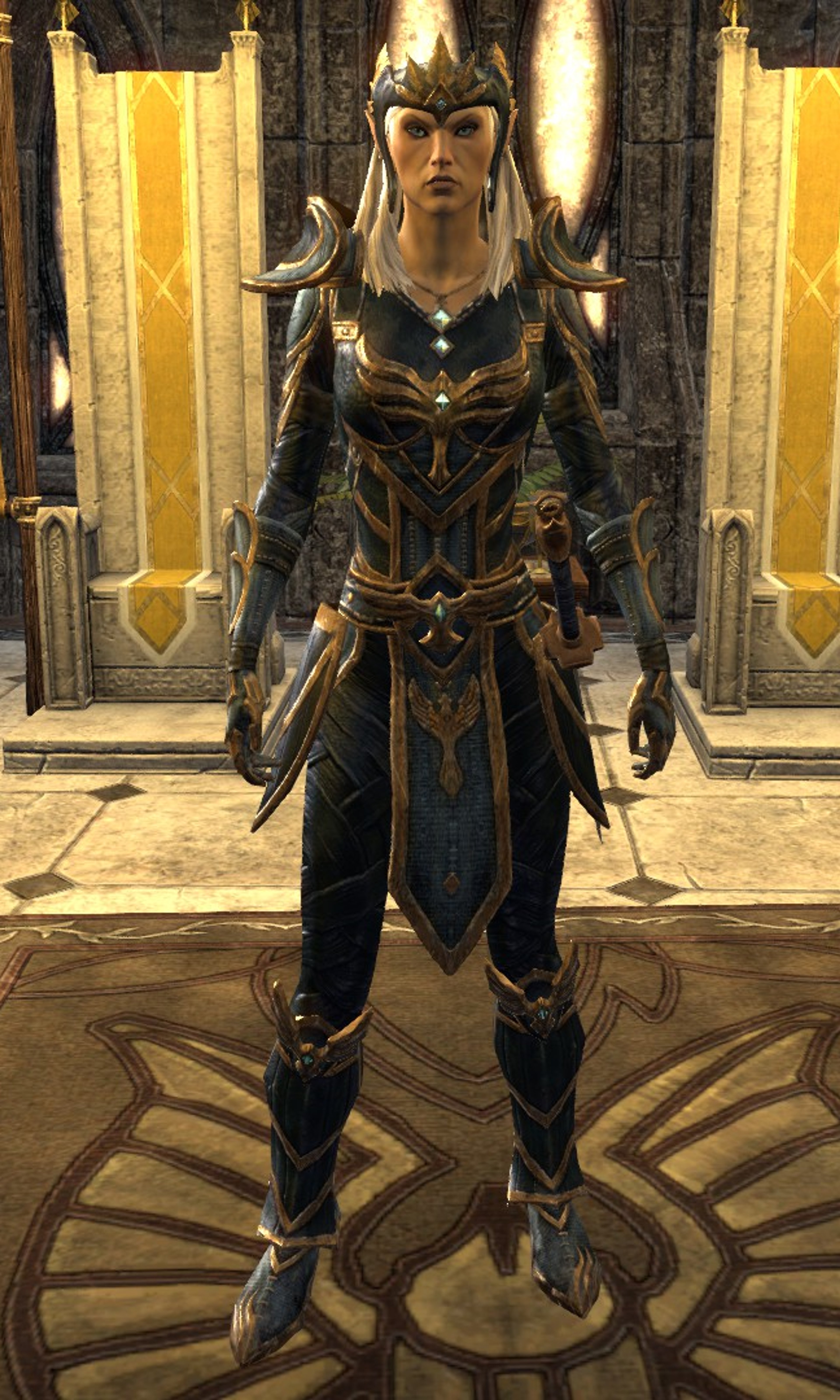 A female Altmer character in ornate golden armor and a crown, standing in a grand hall.