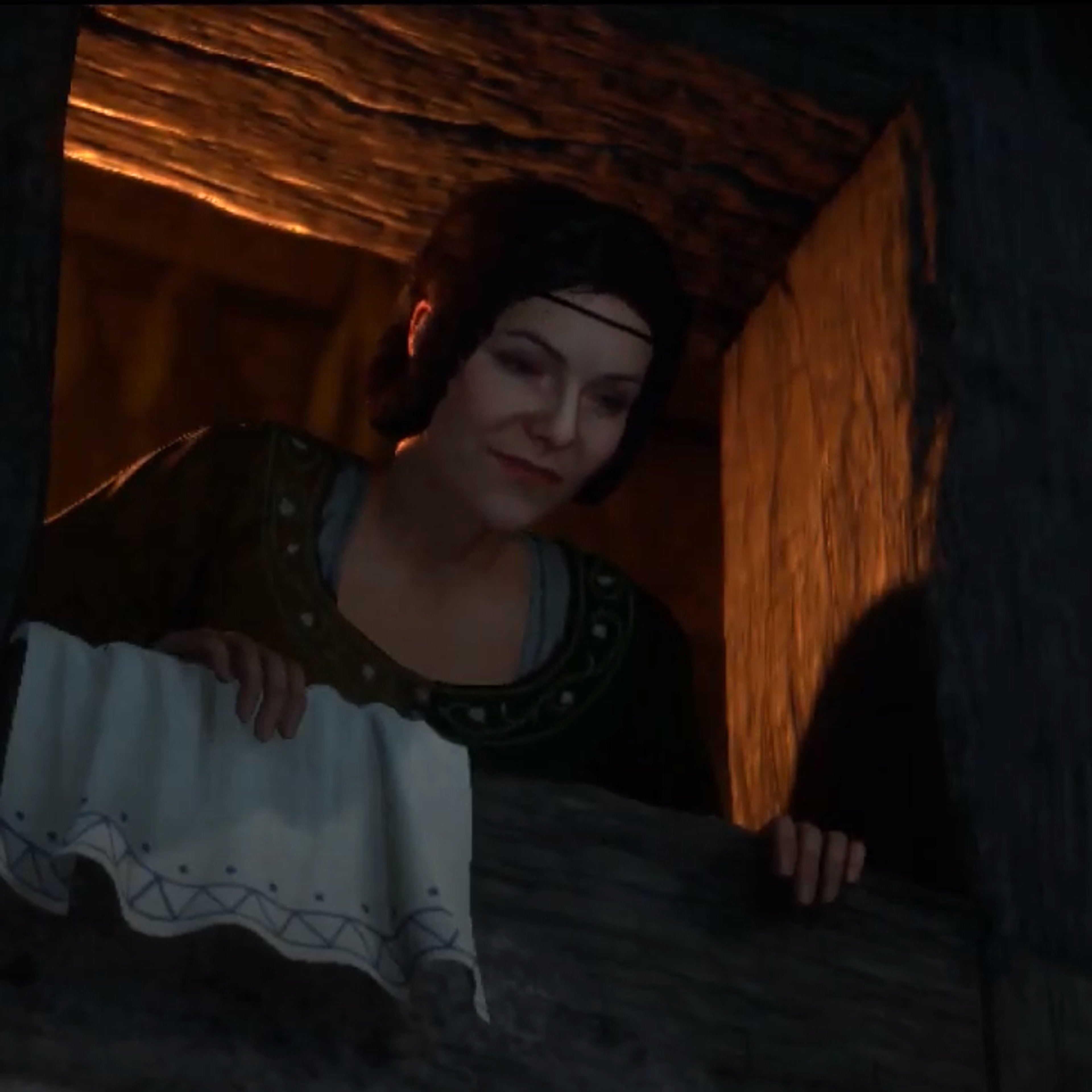A young woman with dark hair in a dimly lit room