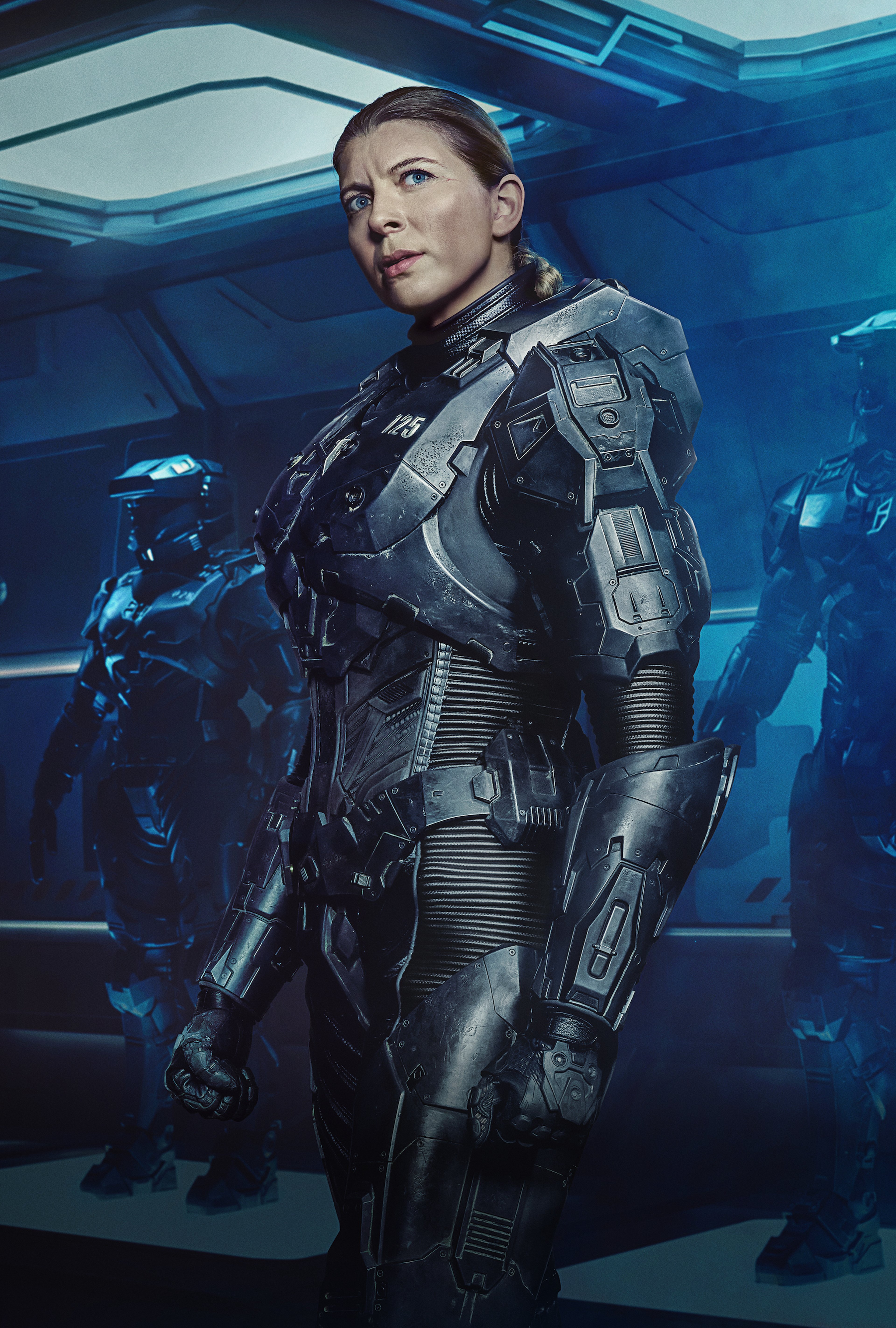 A woman in a futuristic military-style suit with a serious expression