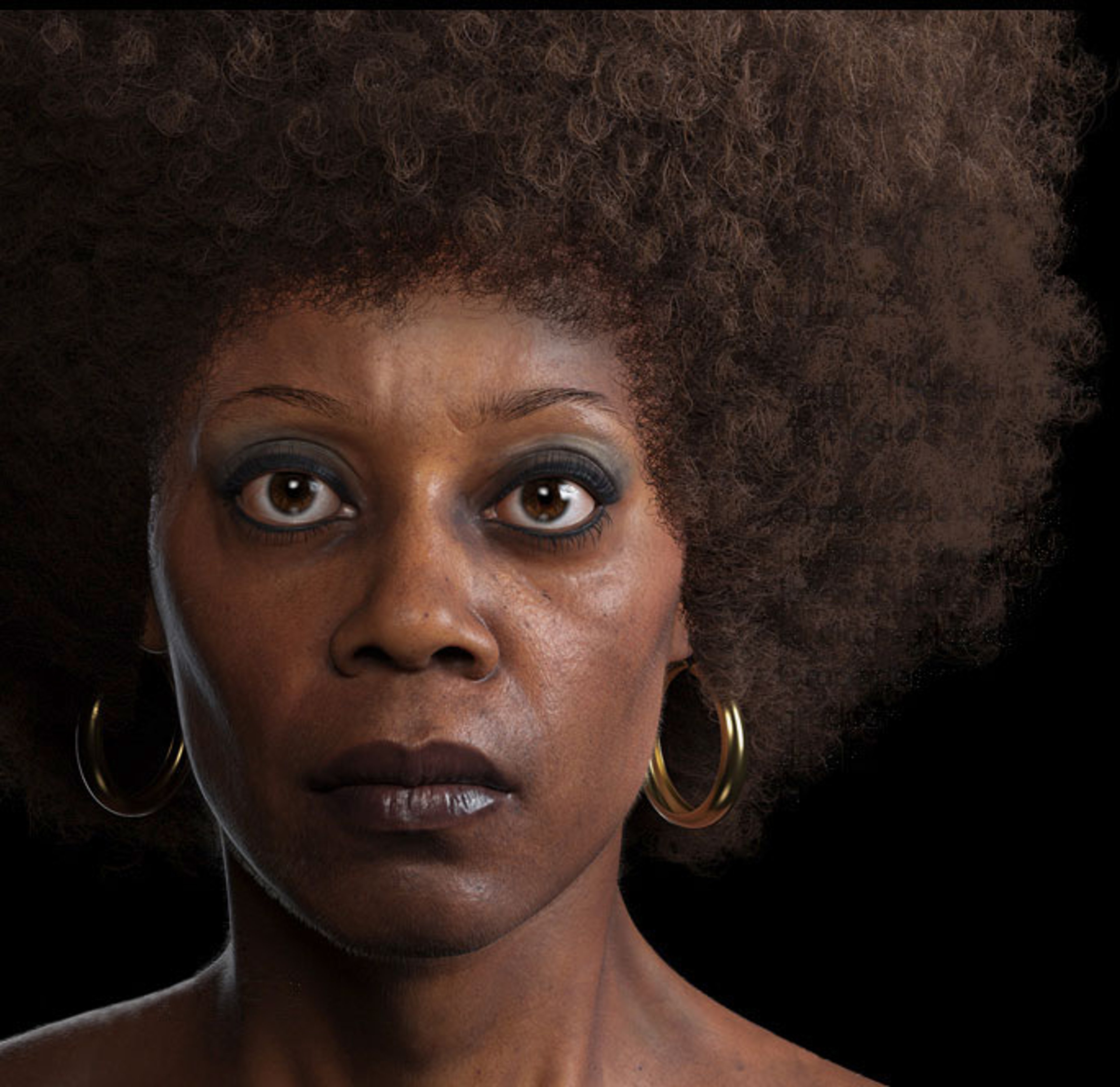 Portrait of a Black woman with curly hair and hoop earrings