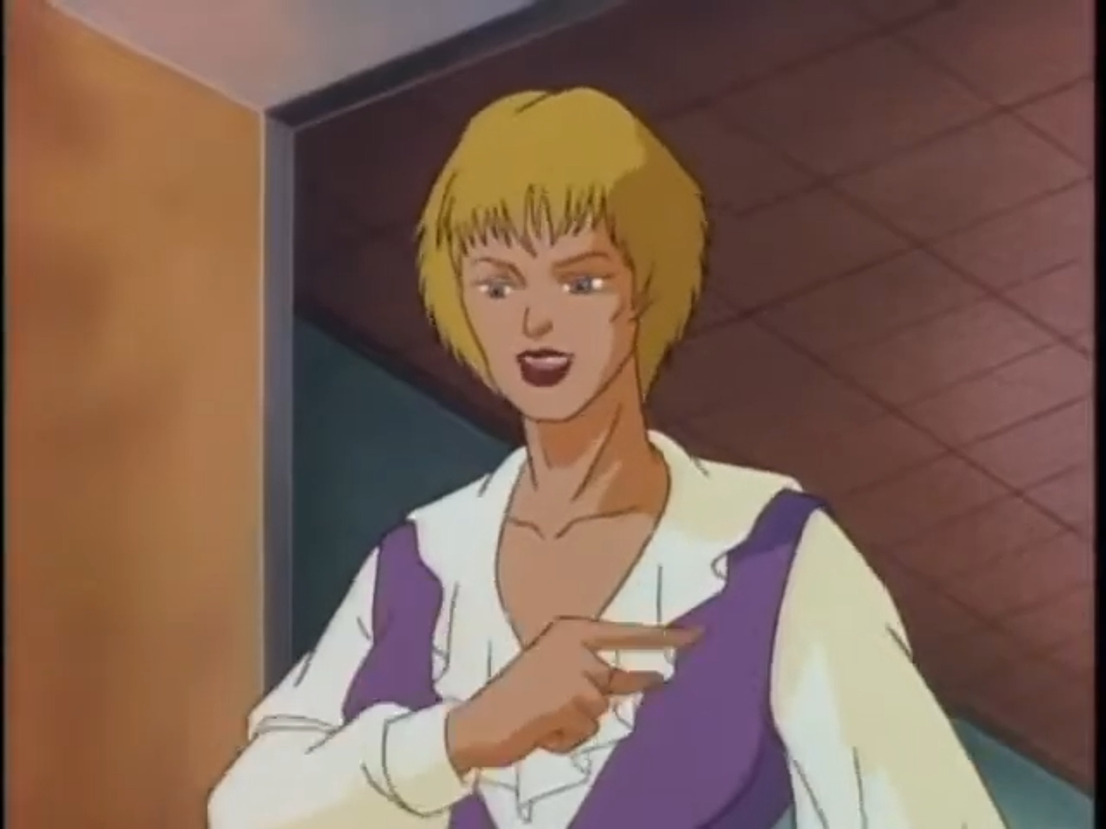 A middle-aged woman with short brown hair wearing a purple blouse, appearing to be a news reporter