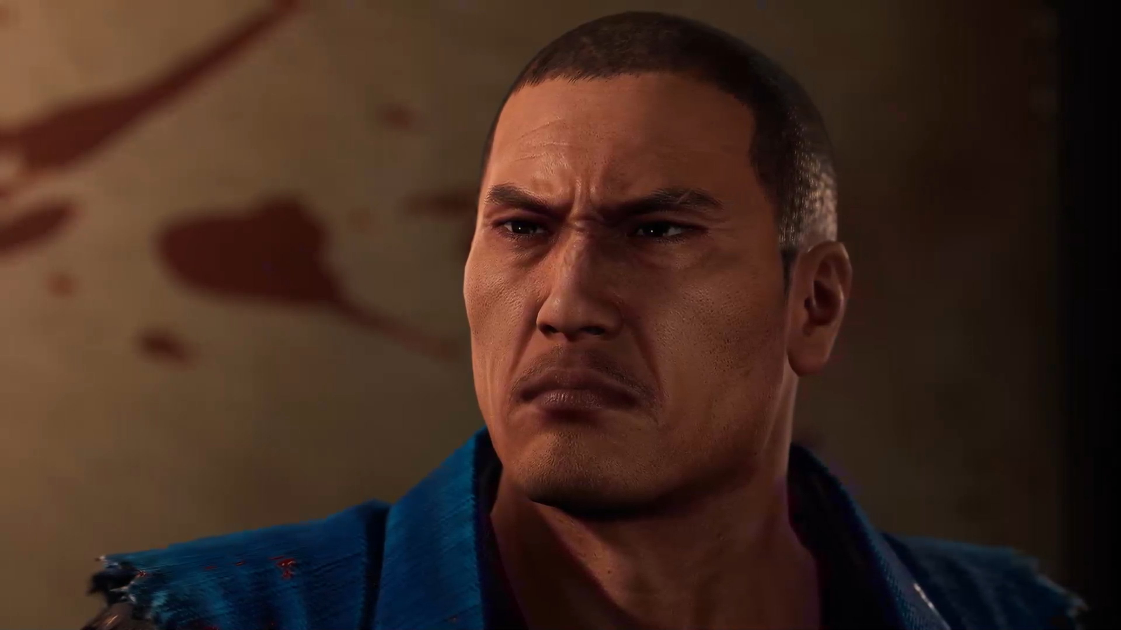 A burly, muscular man with a shaved head and a serious expression