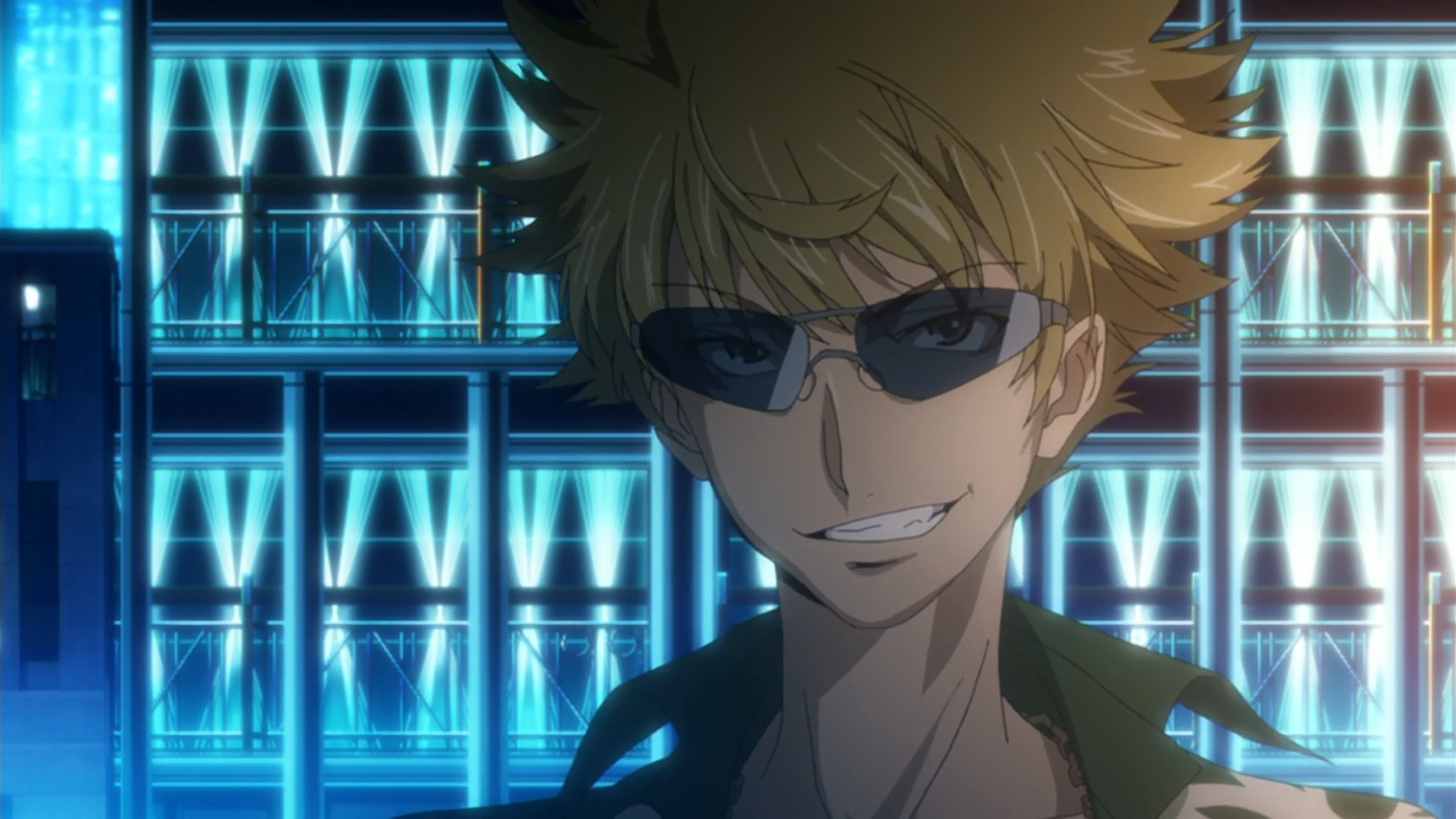 A young man with blonde hair and sunglasses in a high-tech setting