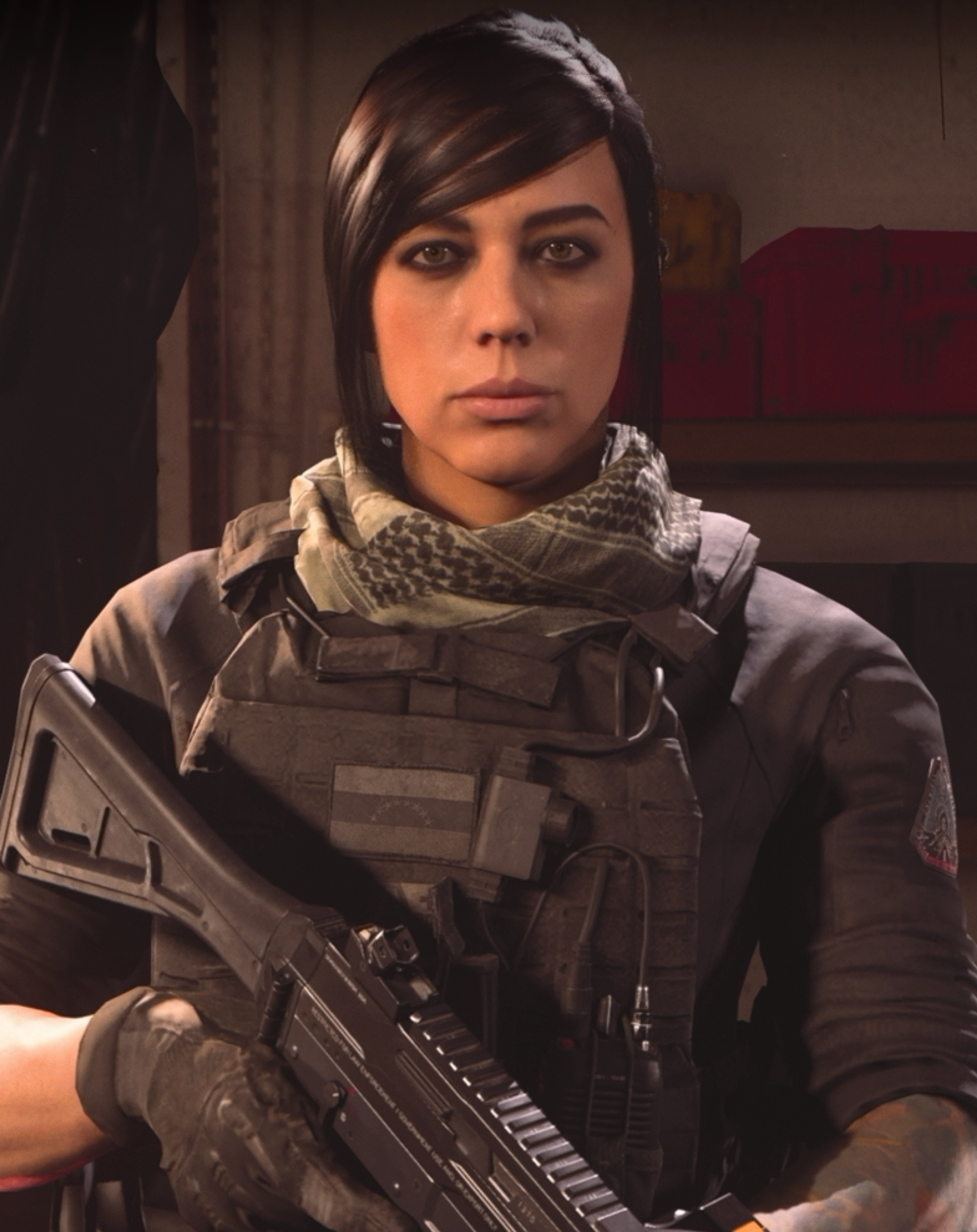 A woman in tactical gear holding a rifle