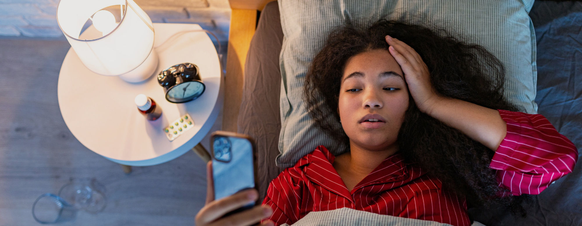 Frau kann nicht schlafen und schaut auf Handy