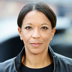 Headshot of Janina Kugel, a woman wearing a black jacket and standing outside.