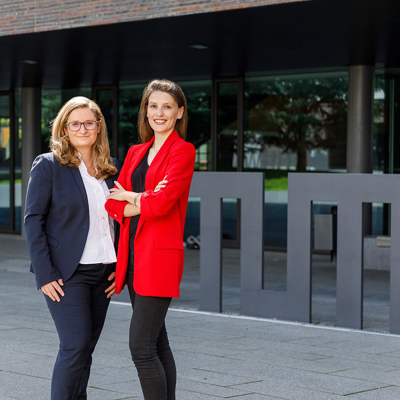 Two women standing next to each other