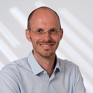 Headshot of Prof. Dr. Helmut Farbmacher , a middle age man smiling on a simple white  background.