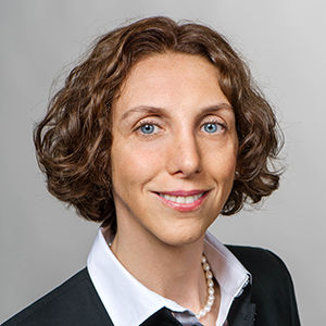 Headshot of Prof. Dr. Luisa Menapace , a middle age woman smiling on a simple white  background.