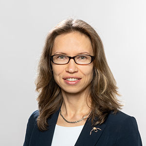 Headshot of Prof. Dr. Svetlana Ikonnikova , a middle age woman smiling on a simple white  background.