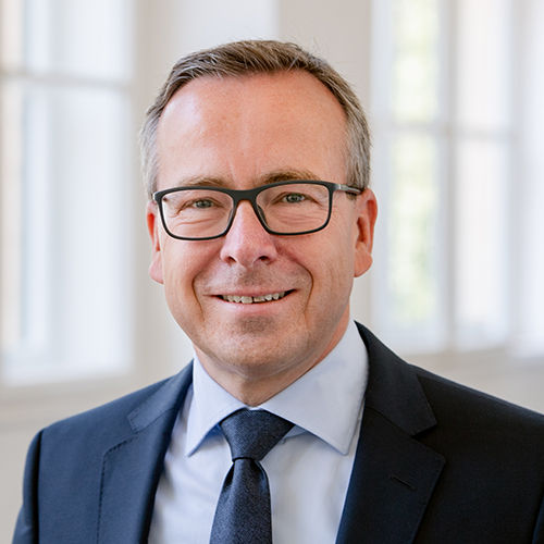 Headshot of Prof. Dr. Gunther Friedl, a middle age man smiling on a simple background.