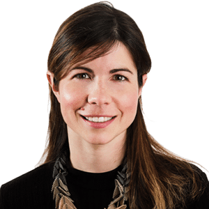 Headshot of Prof. Dr Melanie Richard, a middle aged woman smiling on a simple grey background.