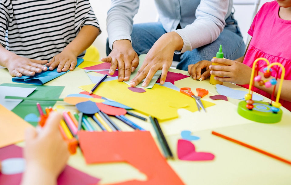 Students engaged in arts and crafts activities in an interactive classroom setting.