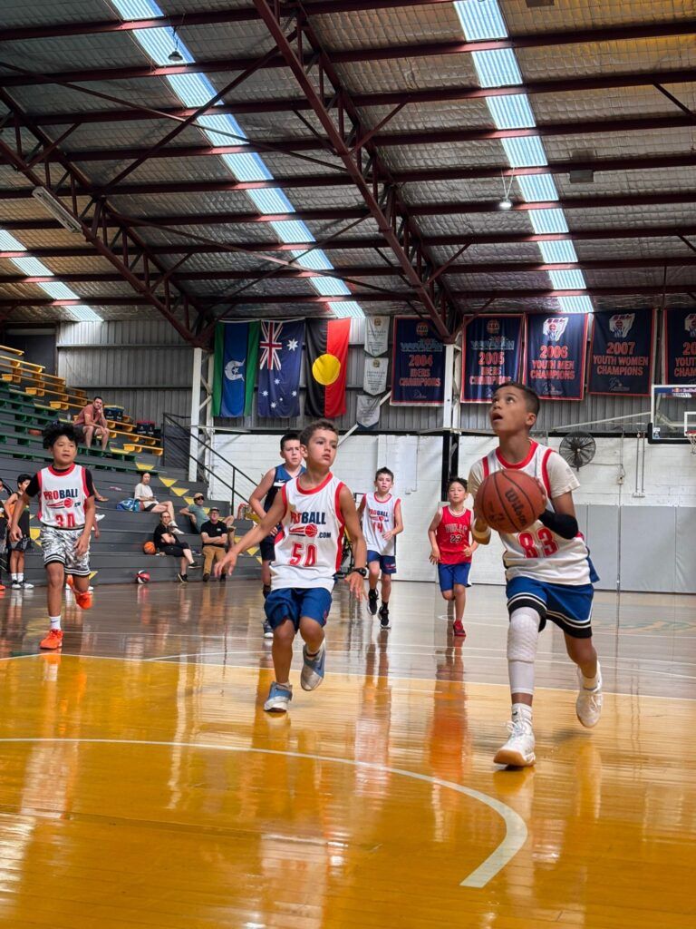 Young basketball players from across Sydney competing in a ProBall Streetball event, showing high-energy games, teams from Mount Druitt and North Sydney, and a full gym of kids playing competitive basketball.