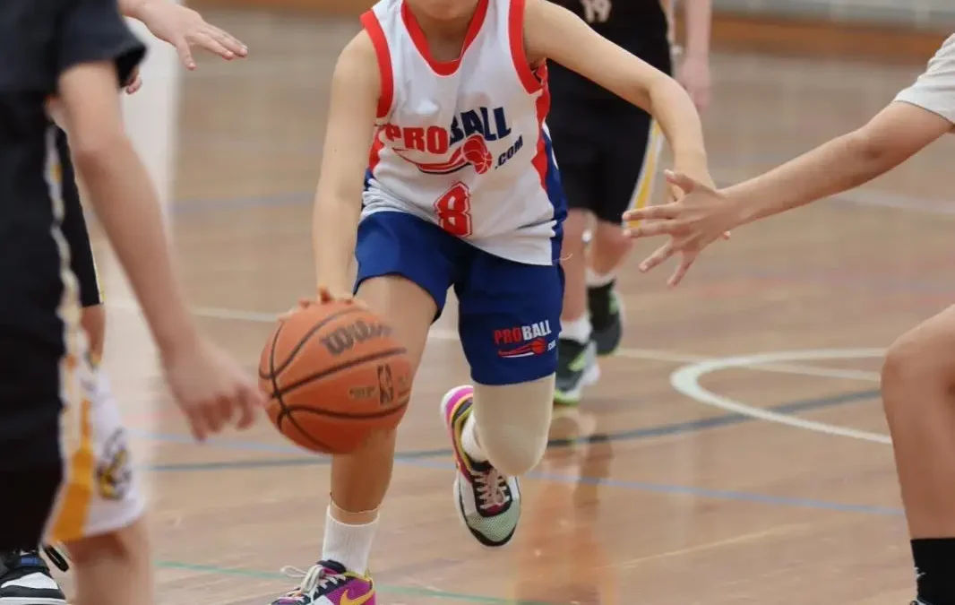 ProBall girl dribbling the basketball during a game at Perry Park Recreation Centre. She is focused and using strong fundamentals, representing ProBall’s Built Different approach to youth basketball.