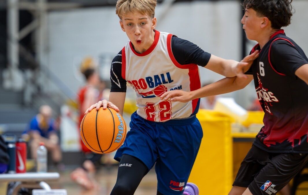 good teammate basketball players showing trust, effort and teamwork during a youth basketball game
