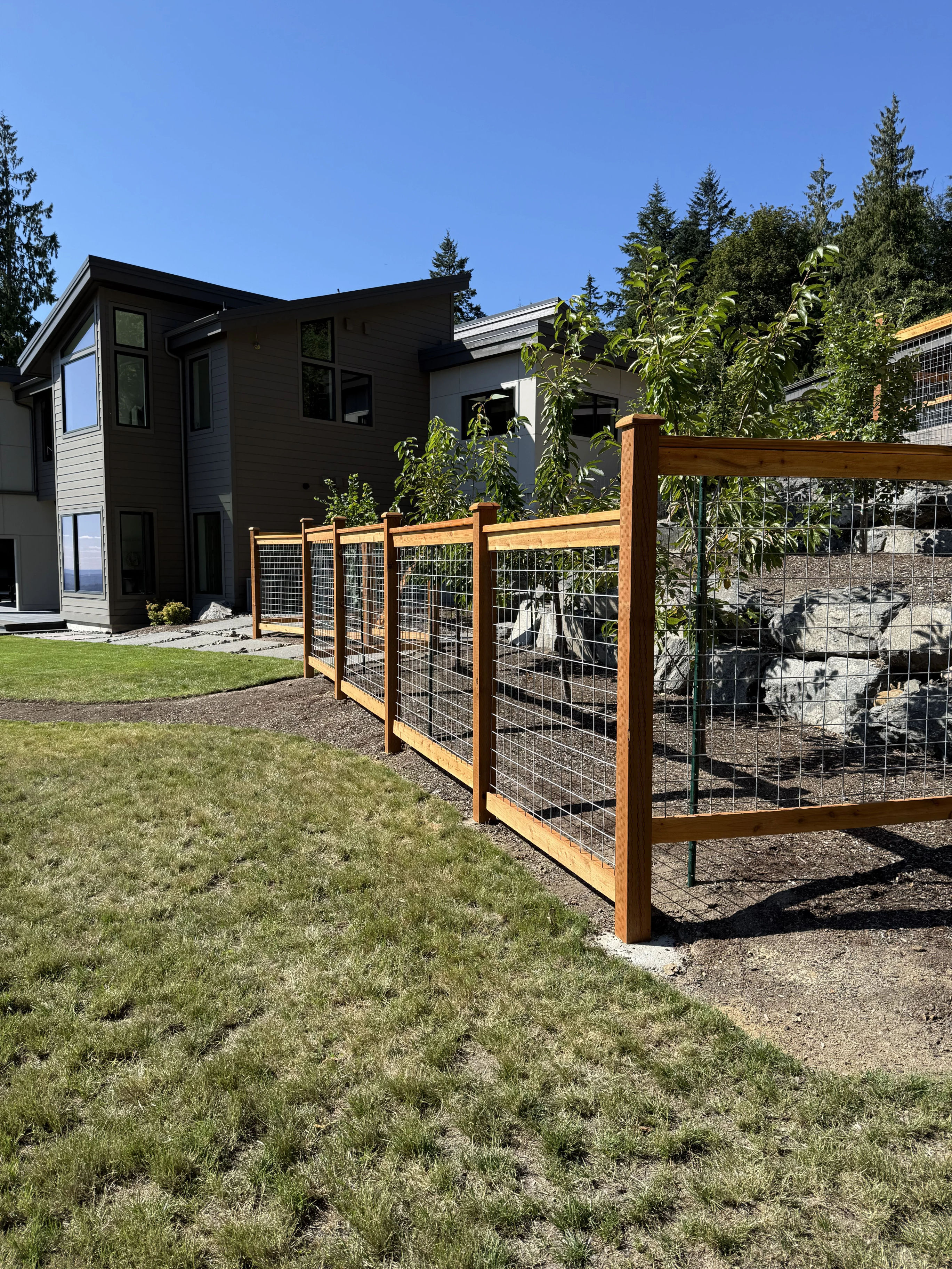 Galvanized hogwire fence with cedar frame showcasing installation