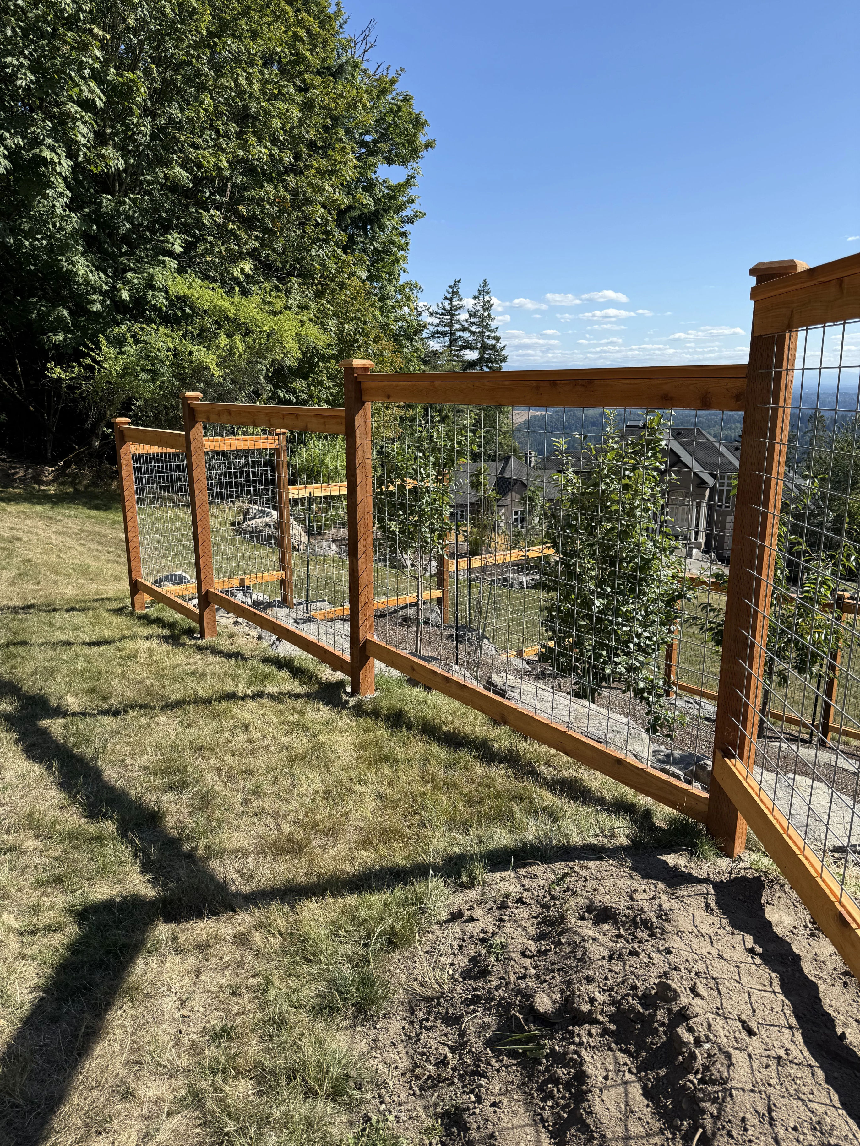 5' galvanized hogwire fence with gate installation in residential setting