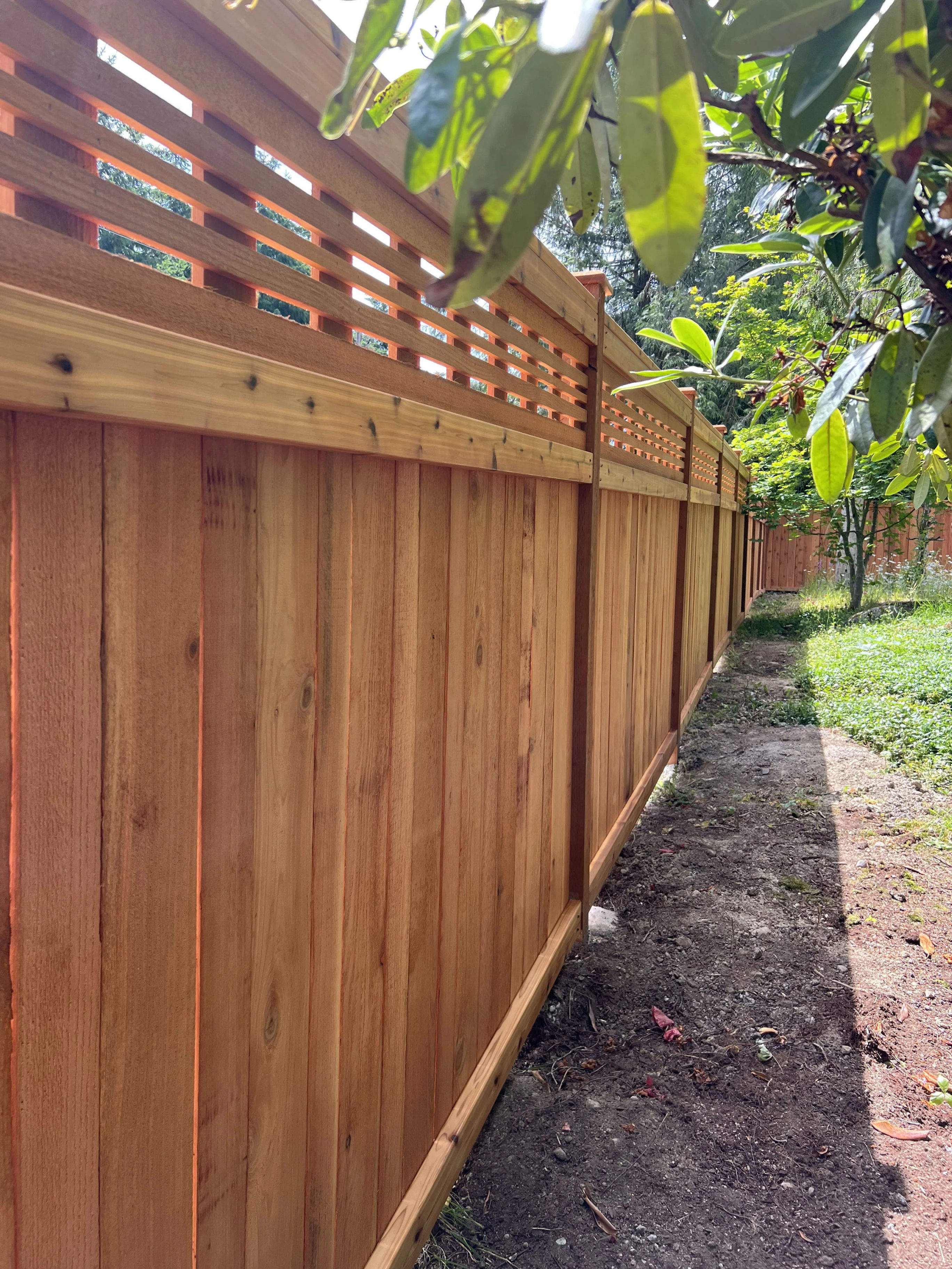 Corner installation of horizontal lattice fence with craftsman foundation
