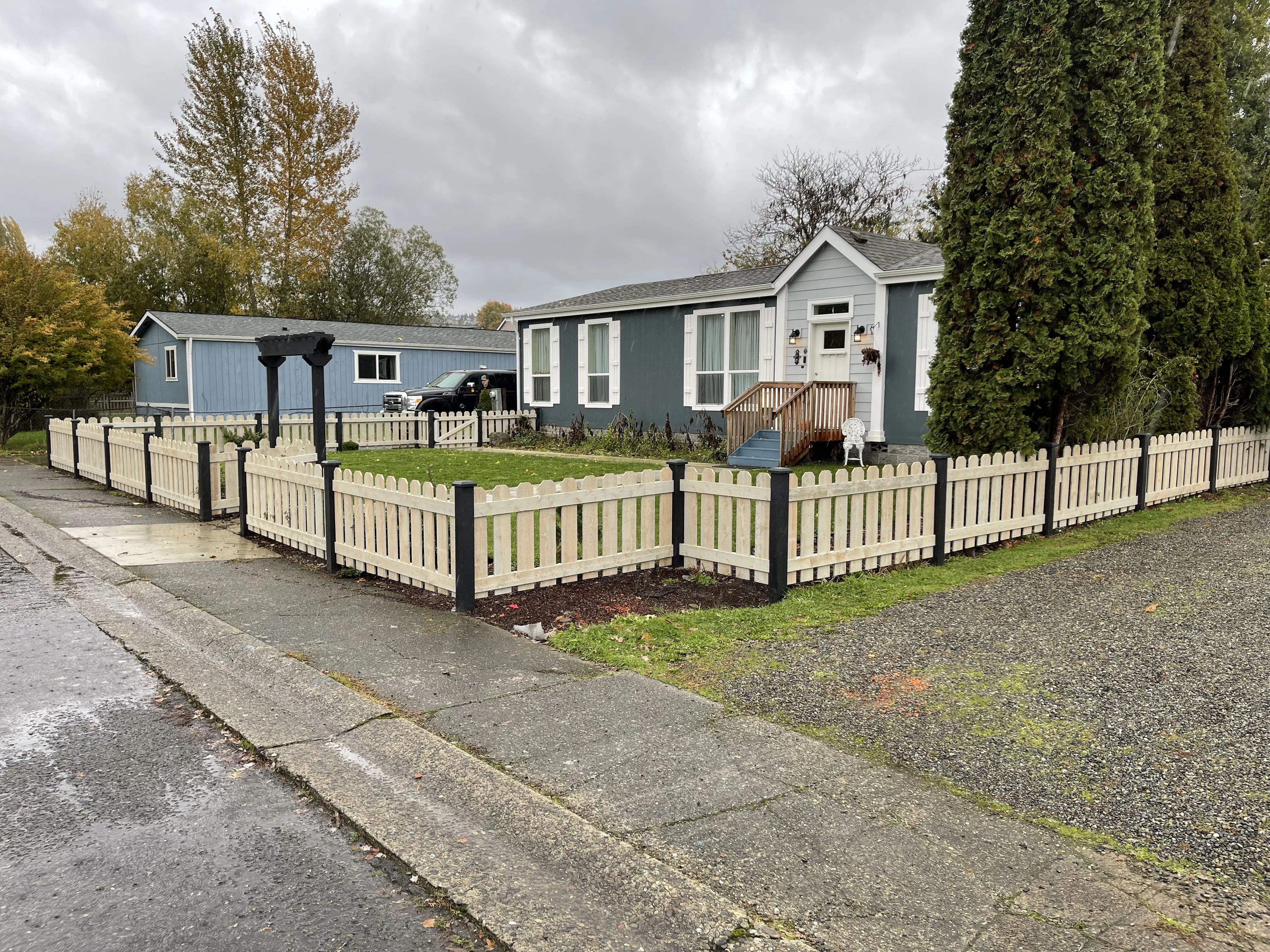 Traditional picket fence providing classic American front yard appeal