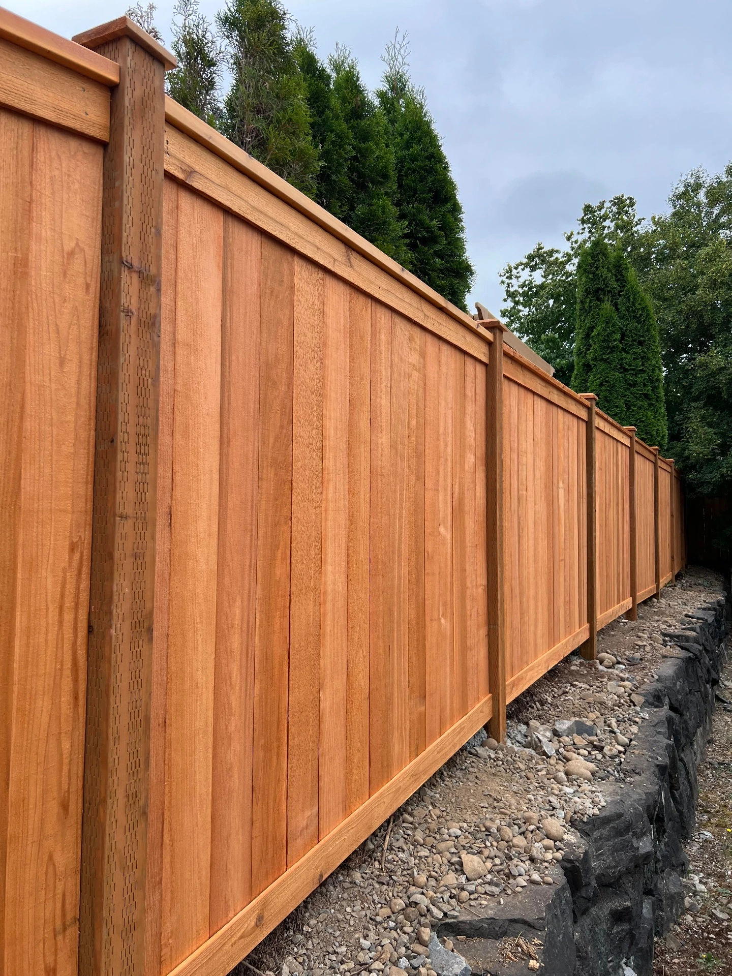 Picture frame fence corner with pergola and flowering tree - Seattle fence installation