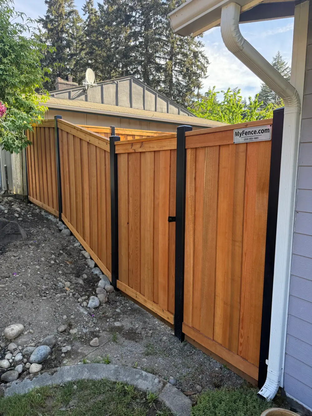 Professional Seattle fence builder crew installing posts on a residential project