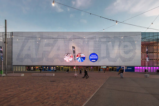 AFAS Live concert hall exterior with LED display, outdoor plaza, and modern architecture for live music events.