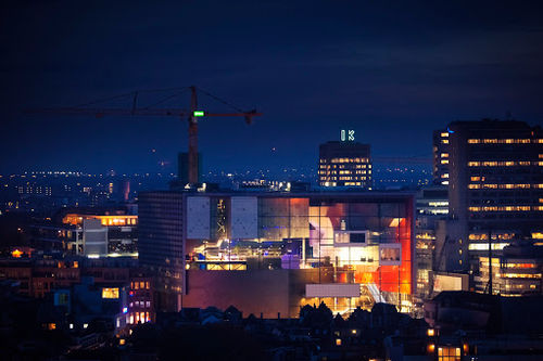 TivoliVredenburg venue at night with illuminated stage, professional lighting rigs, and multi-level performance spaces.