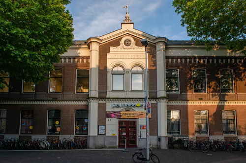 Parnassos Cultural Center facade with classical architecture, large windows, and entrance for live music performances.