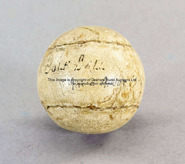 A feather golf ball, circa 1850 with ink inscription by a later owner, diameter 4.5cm., 1 3/4in.