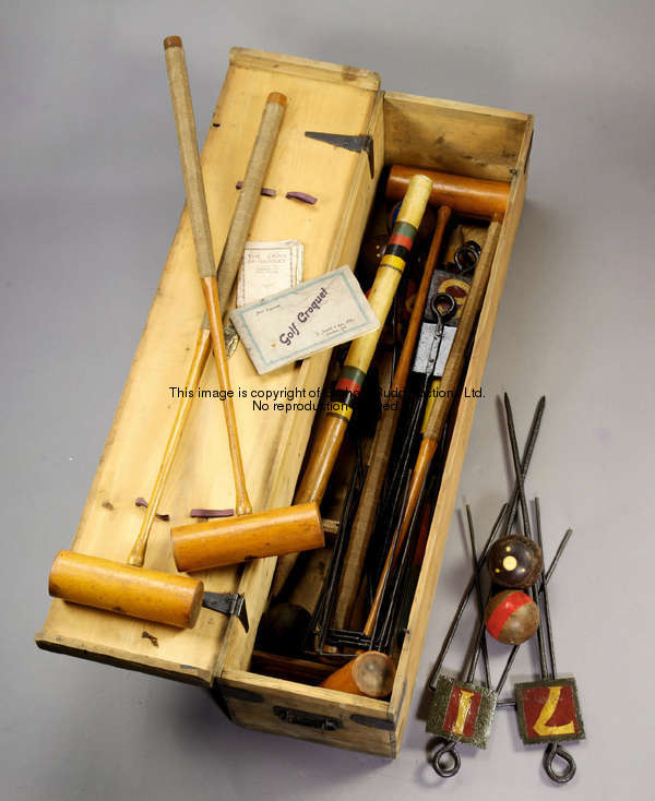 A boxed croquet set by J. Jaques & Son, London, the hinged pine box containing 4 mallets, 7 balls, 1...