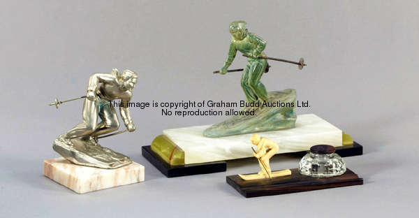 Three skiing figures, one in silvered metal, another in green spelter, both on marble bases; the oth...