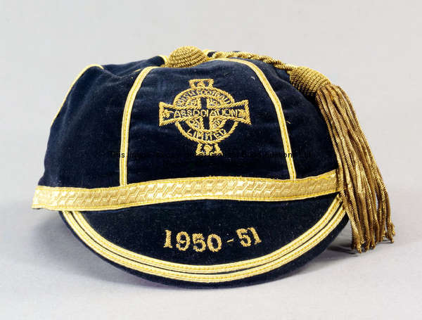 A dark blue Northern Ireland international cap, season 1950-51,  FOOTNOTE  McMichael made three appe...