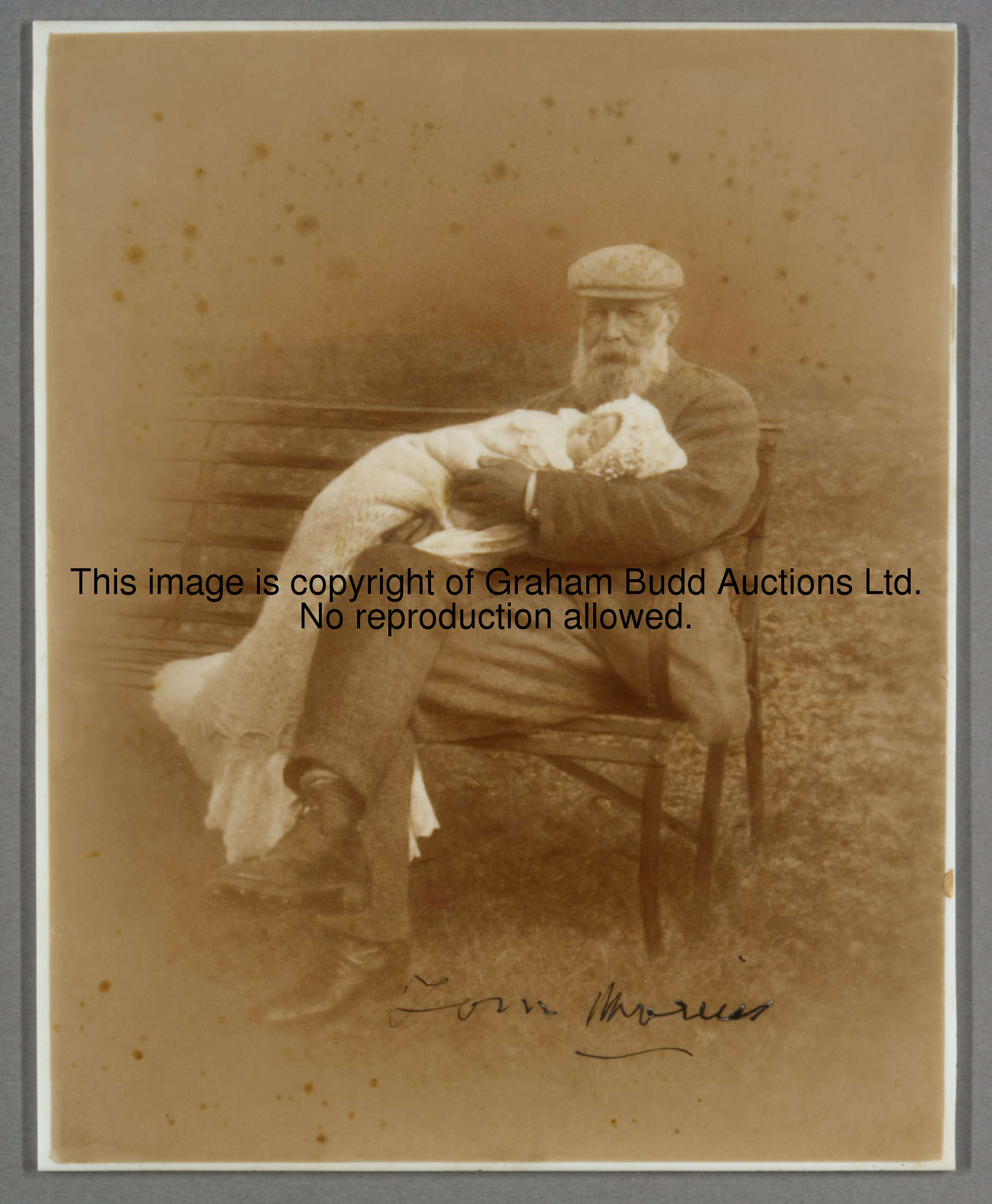 A rare signed photographic glass plate portraying Tom Morris cradling a baby in his arms, signed in ...