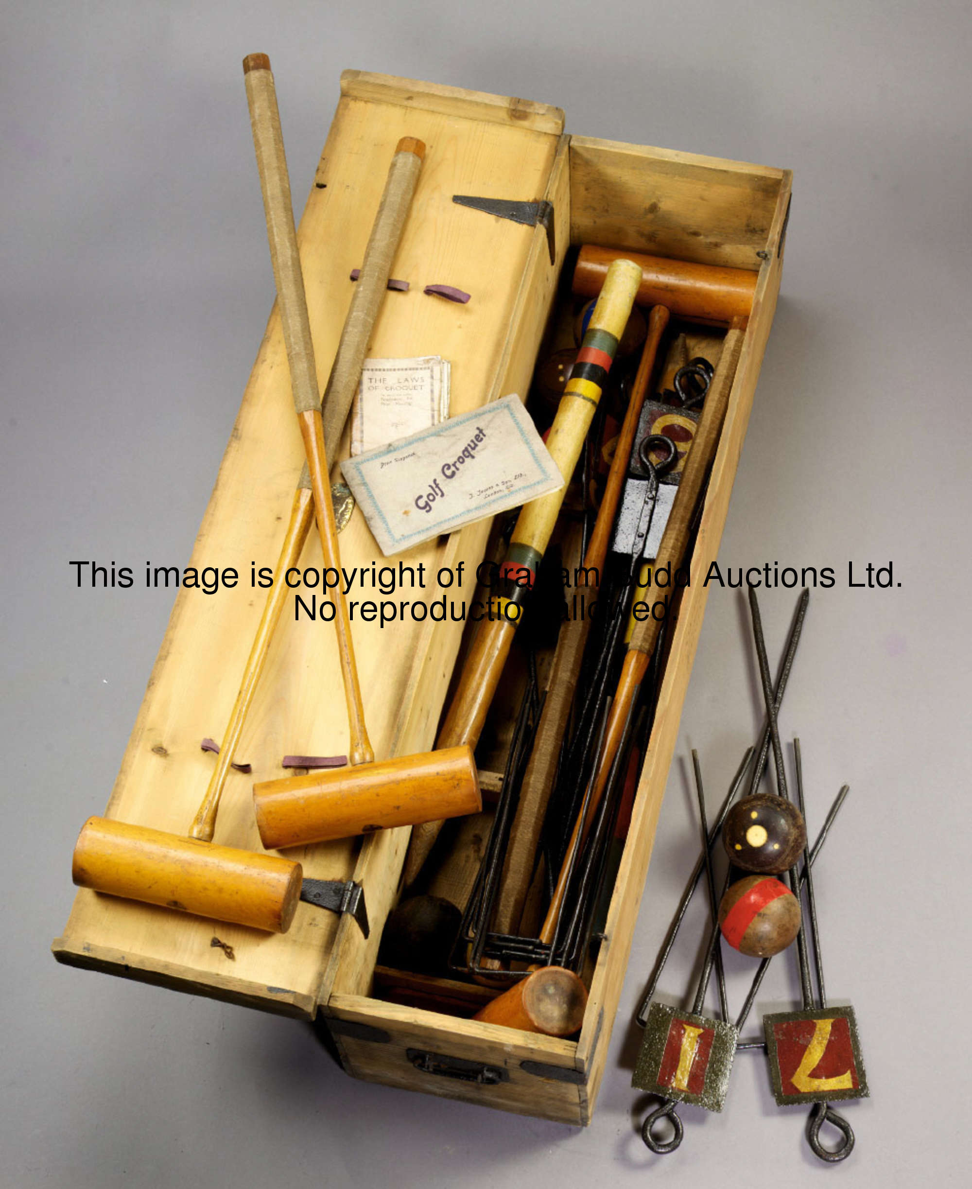 A boxed croquet set by J. Jaques & Son, London, the hinged pine box containing 4 mallets, 7 balls, 1...