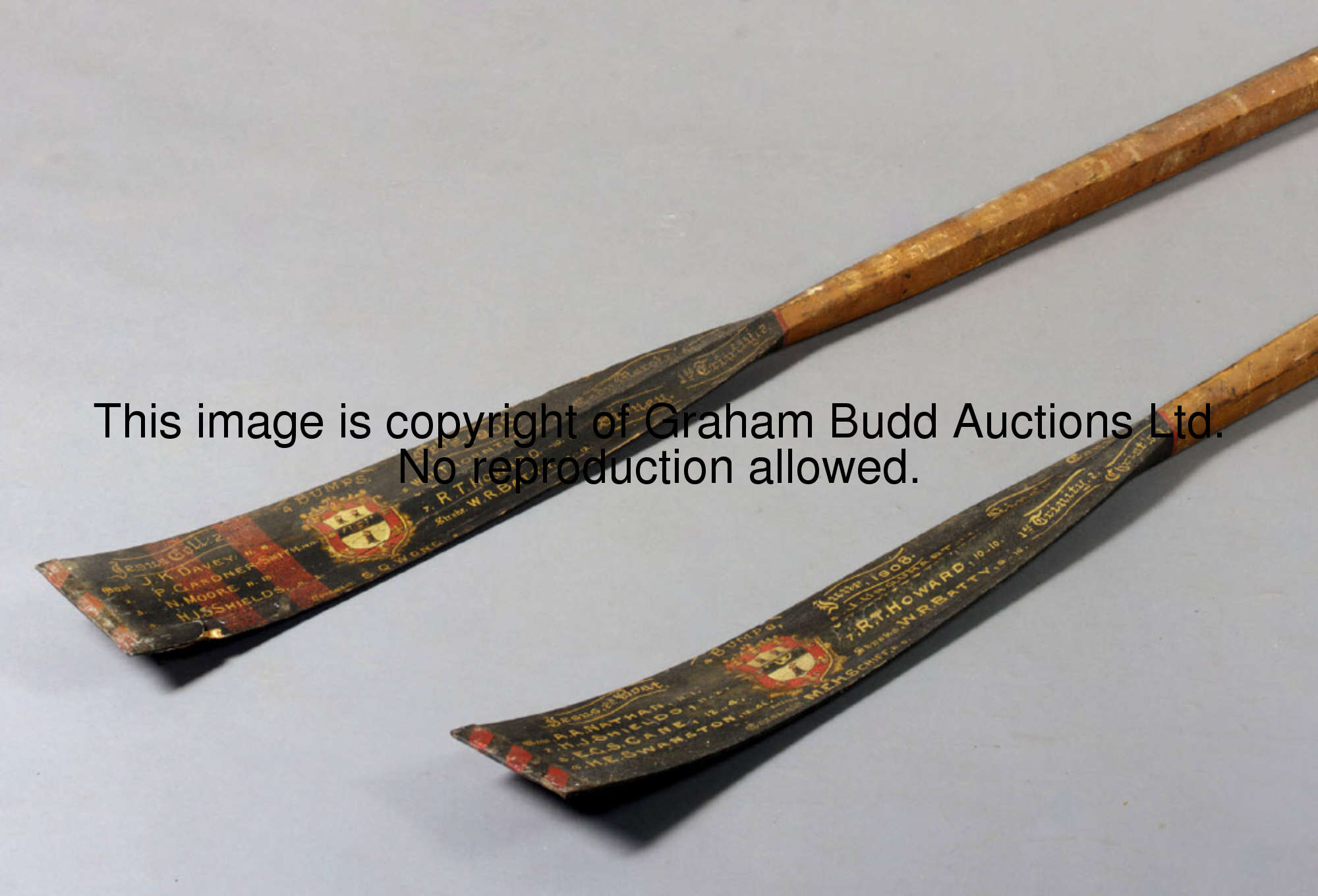 Two commemorative oars from Jesus College, Cambridge, 1908, each blade decorated with the college cr...