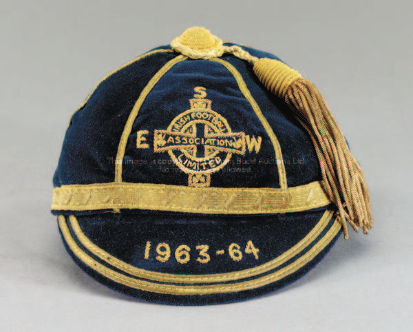 A blue Northern Ireland international cap, season 1963-64, inscribed E, S, W, 1963-64  This cap was ...