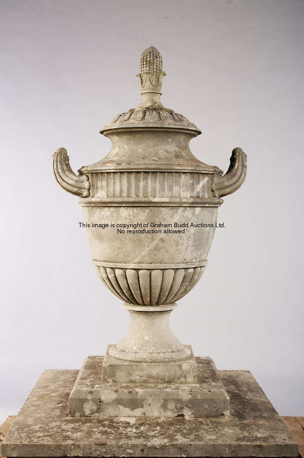 A pair of carved Portland stone urn finials, set on a stepped base, height 132cm., 52in.