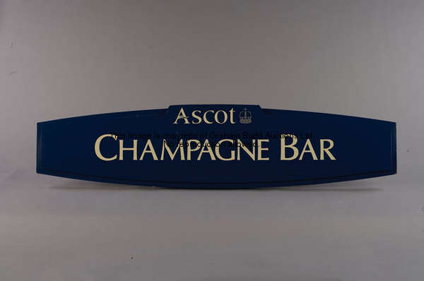 Champagne Bar, a blue painted wooden bar sign, bearing Ascot logo, white lettering, 35 by 150cm., 13...