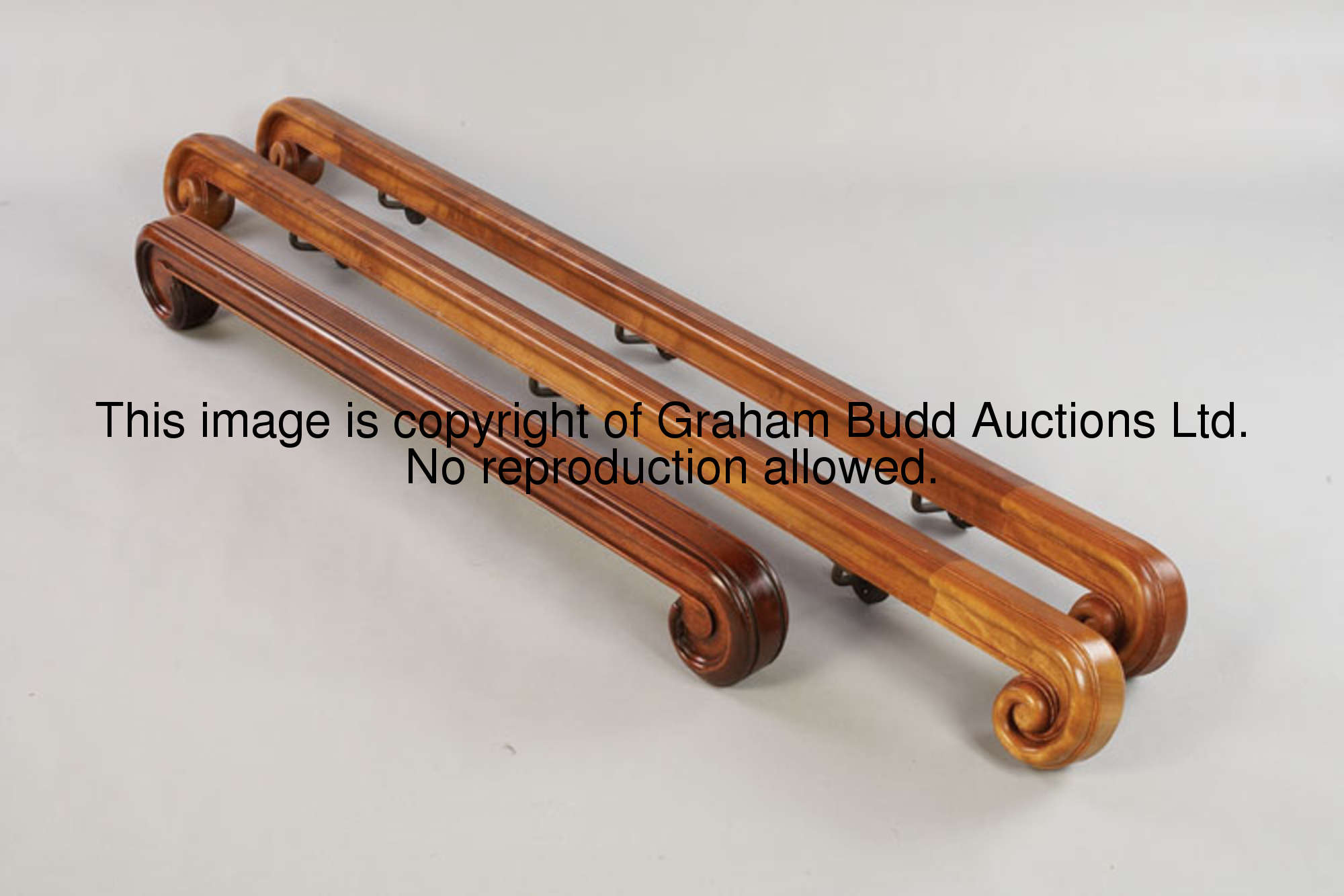 A pair of hand rails from the Royal Box staircase, polished wood, each rail with scroll terminals, m...