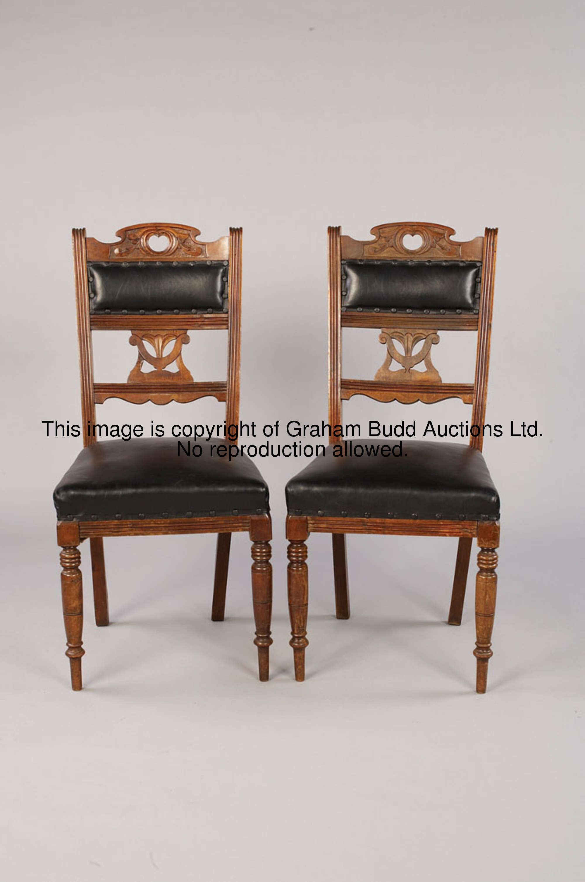 A pair of Edwardian side chairs, beech with carved details, black leather upholstery, height 97cm., ...