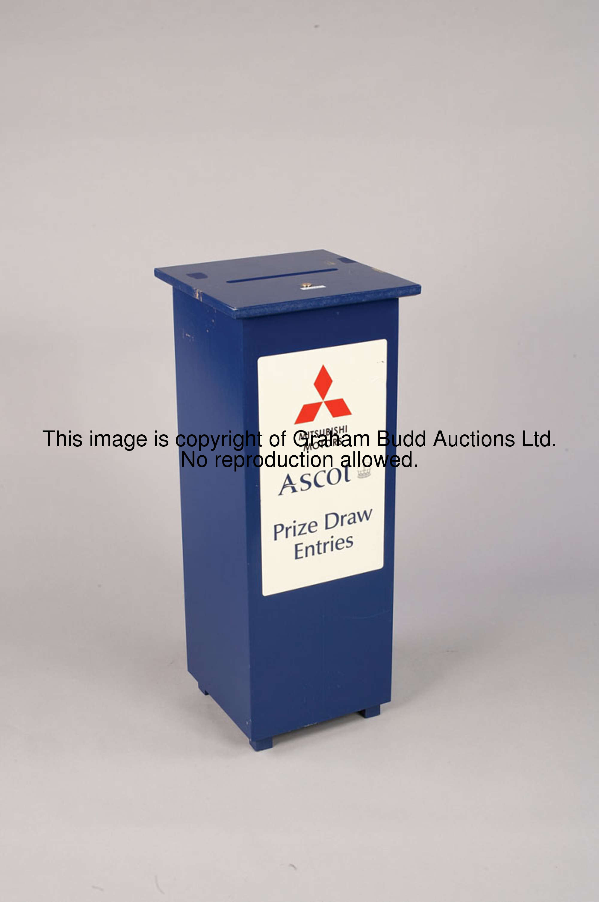 An Ascot prize draw entry box, a blue painted wooden box with sponsor's logo and inscribed ASCOT, PR...