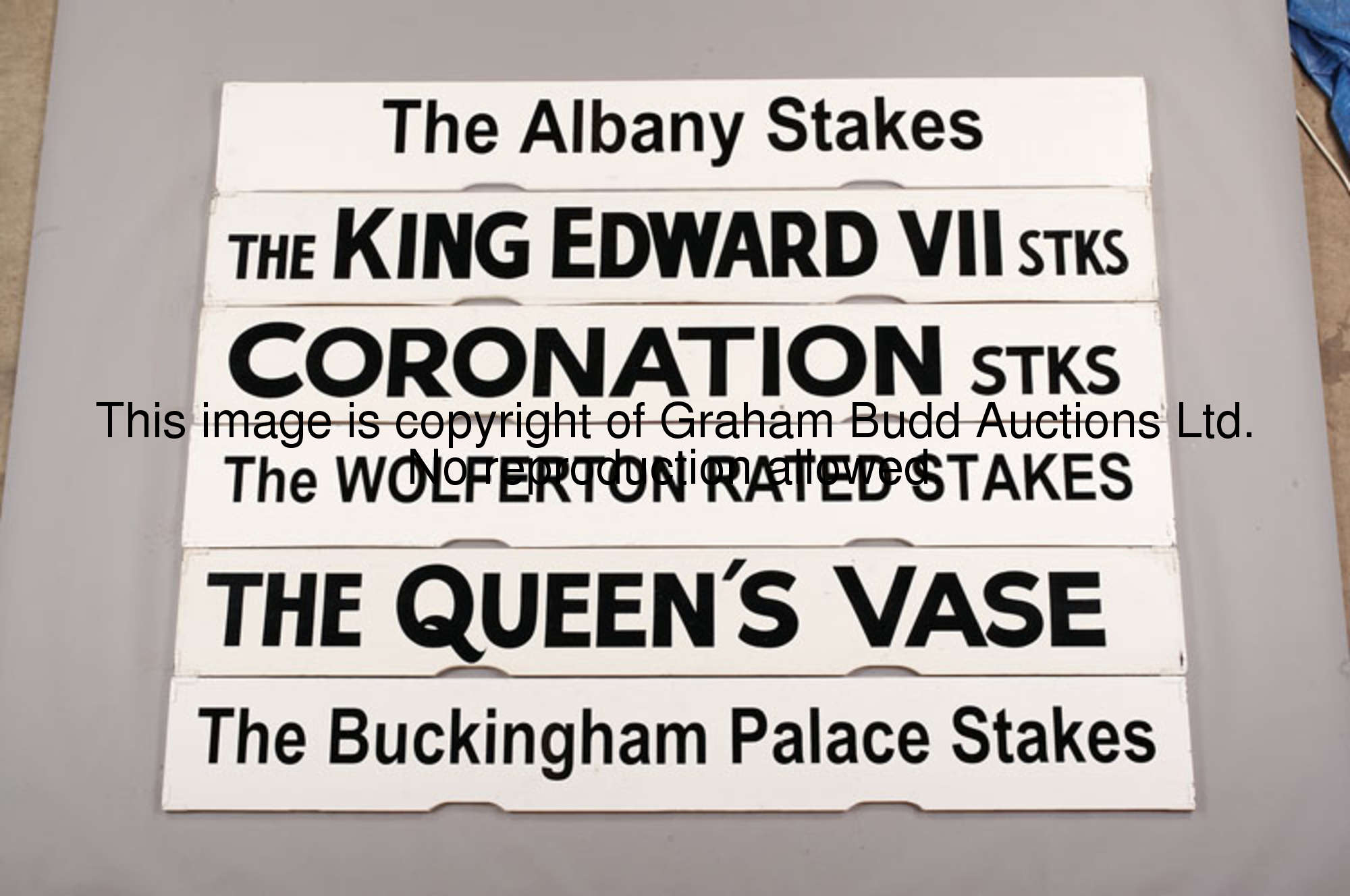 The Wolferton Rated Stakes, a white painted Spagnoletti Royal Ascot race board with black lettering,...